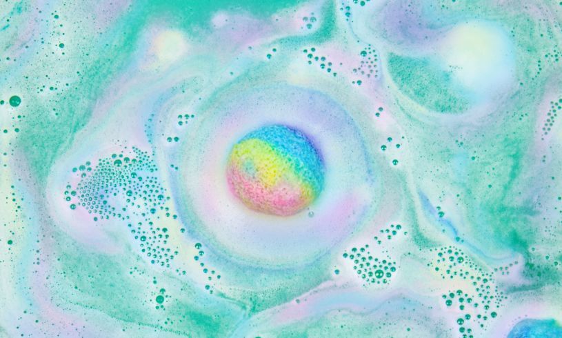 Unicorn poo bath bombs dissolve to make a colorful bath swirl