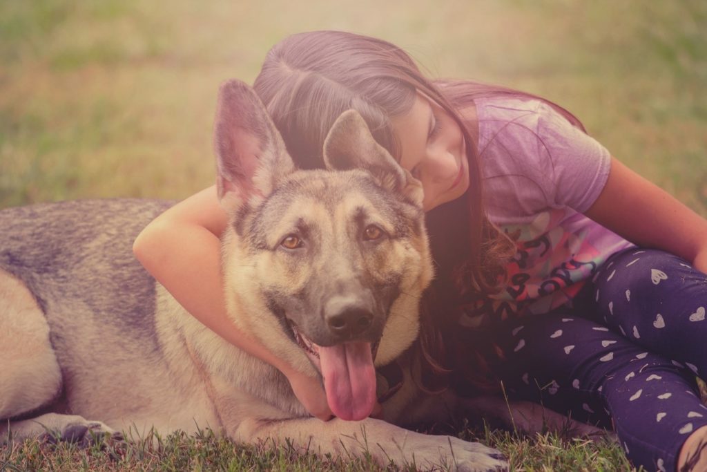 Girl cuddling her dog