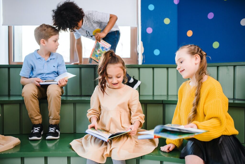 Children reading books to develop their language