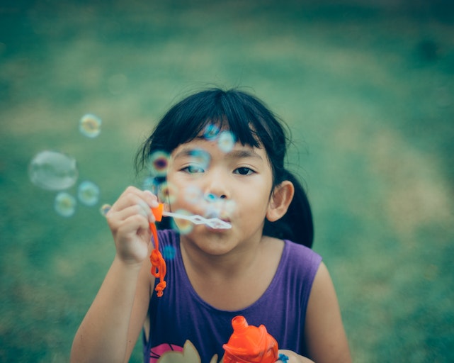 Kids blowing bubbles spring activities