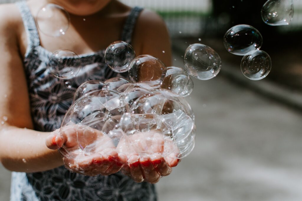 Toddler blowing bubbles