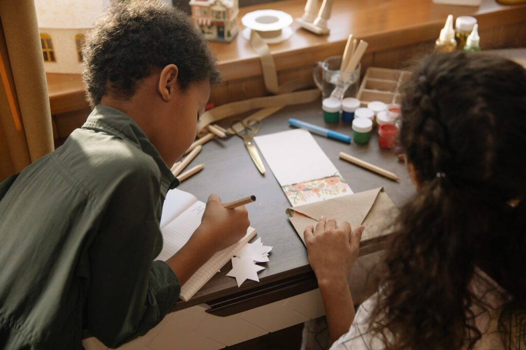 Kids making thank you cards